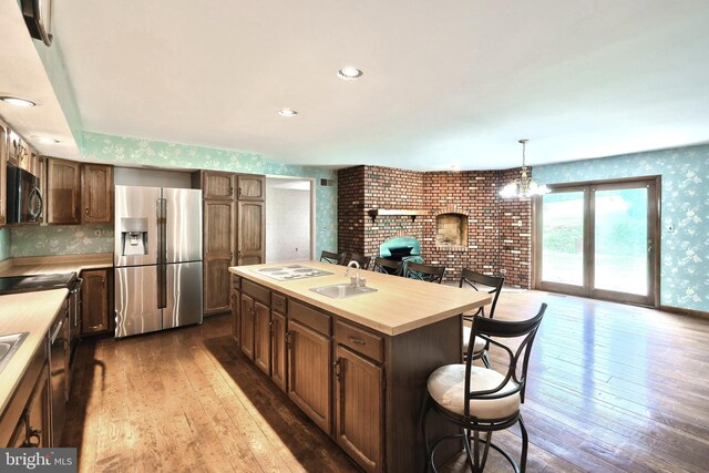 3314 Skyview Dr, Glenville, PA 17329 - kitchen featuring stainless steel fridge, black microwave, a sink, a fireplace, and light countertops