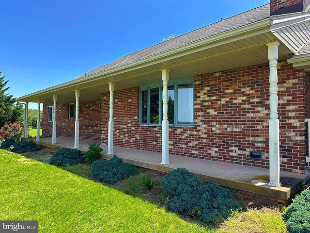 3314 Skyview Dr, Glenville, PA 17329 - view of side of property featuring brick siding, a porch, and a lawn