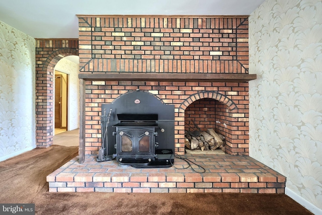 3314 Skyview Dr, Glenville, PA 17329 - detailed view of wallpapered walls, carpet flooring, a wood stove, and baseboards