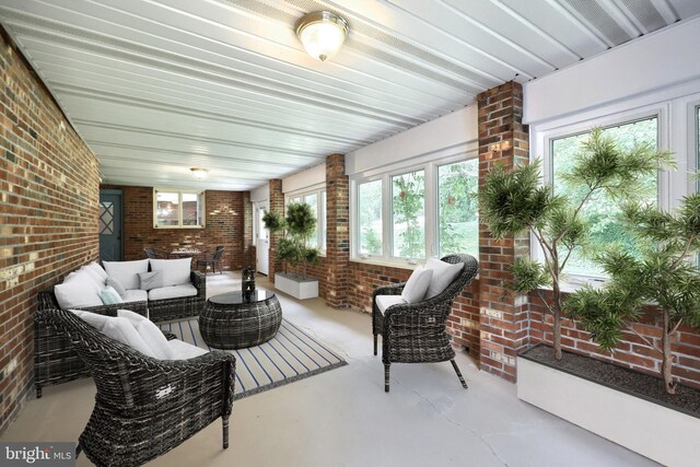3314 Skyview Dr, Glenville, PA 17329 - sunroom with finished concrete floors, brick wall, and plenty of natural light