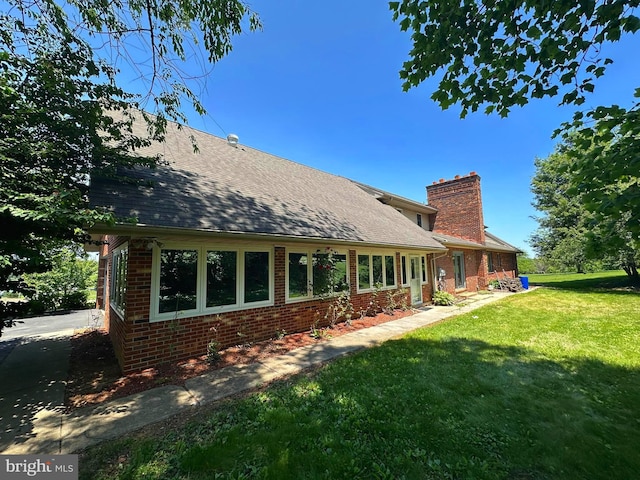 3314 Skyview Dr, Glenville, PA 17329 - back of house with brick siding, a chimney, a lawn, and a shingled roof