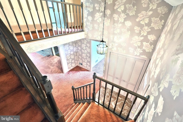 3314 Skyview Dr, Glenville, PA 17329 - stairway featuring wallpapered walls, carpet, and a chandelier