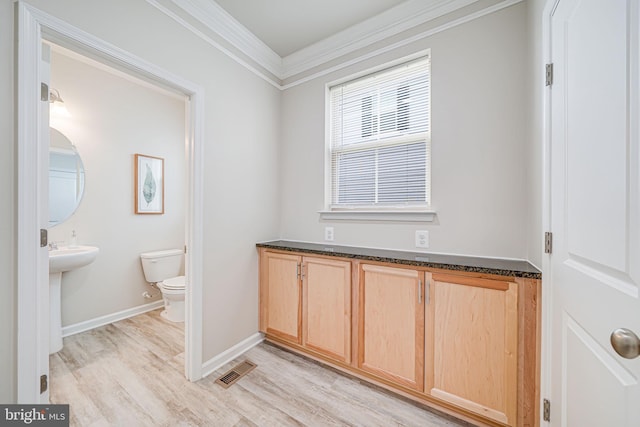 9563 Jefferson St, Manassas, VA 20110 - half bath featuring ornamental molding, toilet, wood finished floors, and baseboards