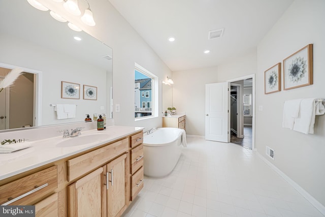 9563 Jefferson St, Manassas, VA 20110 - bathroom with vanity, a soaking tub, tile patterned floors, recessed lighting, and baseboards