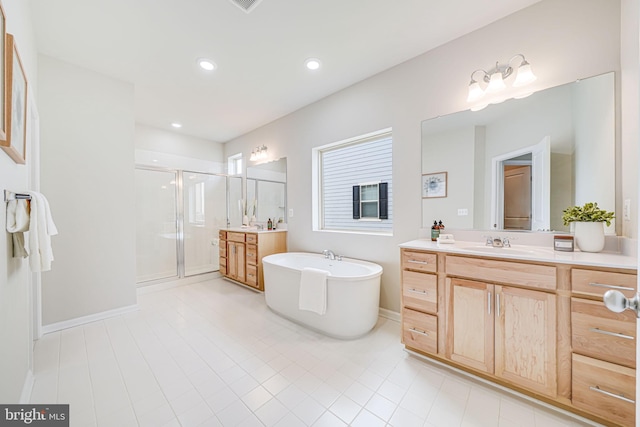 9563 Jefferson St, Manassas, VA 20110 - bathroom with a shower stall, two vanities, a freestanding bath, tile patterned flooring, and recessed lighting
