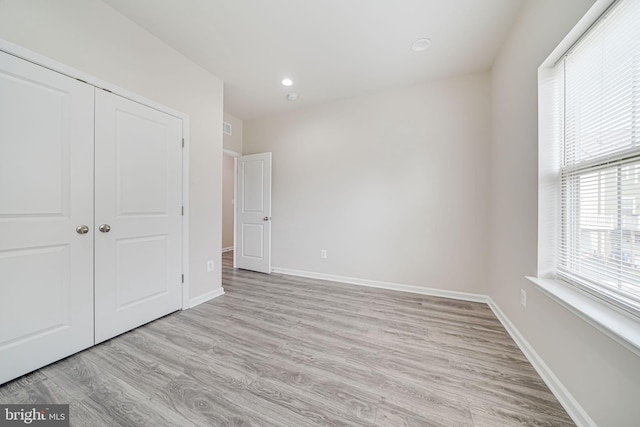 9563 Jefferson St, Manassas, VA 20110 - unfurnished bedroom with light wood-style floors, a closet, baseboards, and recessed lighting