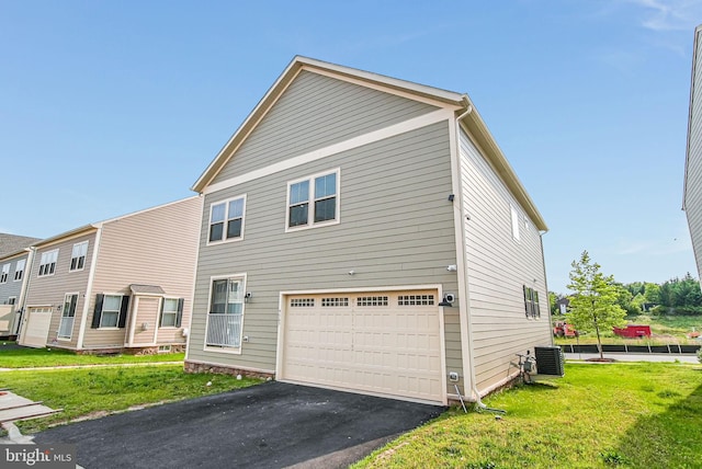 9563 Jefferson St, Manassas, VA 20110 - rear view of house featuring an attached garage, central air condition unit, driveway, and a lawn