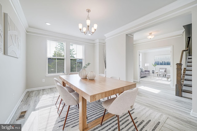 9563 Jefferson St, Manassas, VA 20110 - dining area featuring stairway, a chandelier, light wood-type flooring, baseboards, and ornamental molding