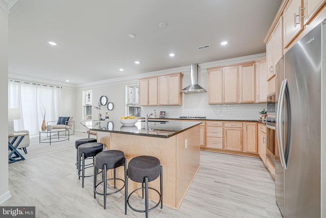 9563 Jefferson St, Manassas, VA 20110 - kitchen featuring stainless steel appliances, wall chimney exhaust hood, light brown cabinets, ornamental molding, and light wood-type flooring