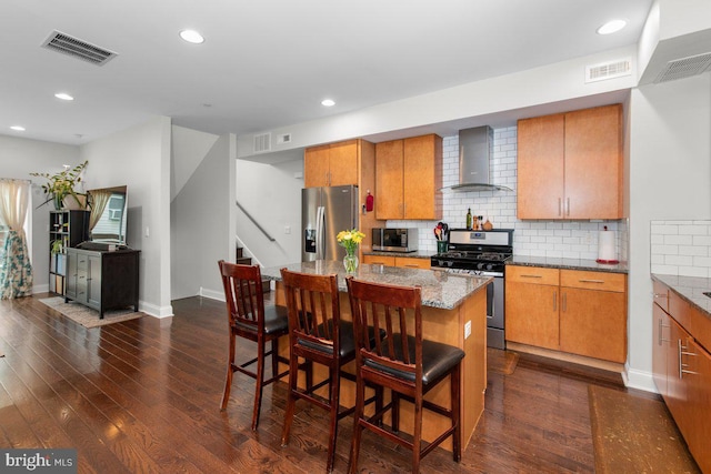 1204 S 12th St Unit O, Philadelphia, PA 19147 - kitchen with wall chimney exhaust hood, appliances with stainless steel finishes, dark wood finished floors, backsplash, and baseboards