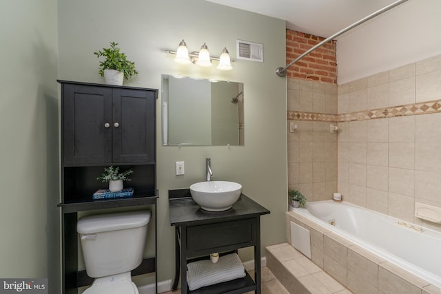 230 N Port St, Baltimore, MD 21224 - bathroom with toilet, vanity, tiled shower / bath, and tile patterned flooring