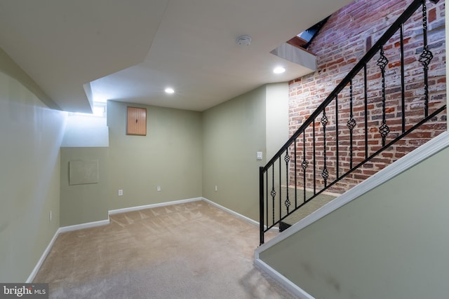 230 N Port St, Baltimore, MD 21224 - finished below grade area featuring carpet, baseboards, stairs, recessed lighting, and brick wall
