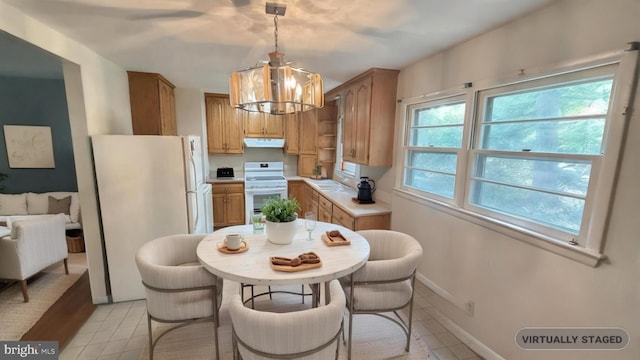 21305 Three Notch Rd, Lexington Park, MD 20653 - kitchen with white appliances, a chandelier, light tile patterned floors, under cabinet range hood, and light countertops