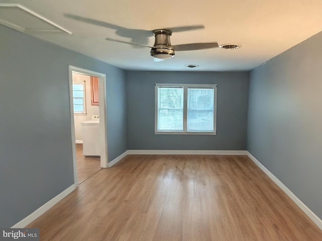 21305 Three Notch Rd, Lexington Park, MD 20653 - spare room with washer / clothes dryer, wood finished floors, baseboards, and ceiling fan