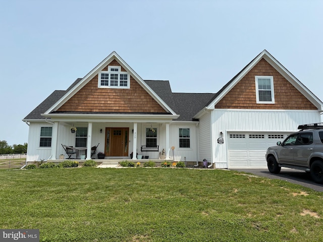 215 Naples Way, Charles Town, WV 25414 - view of front of house featuring a porch, asphalt driveway, a front lawn, and a garage