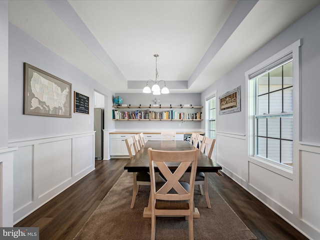 215 Naples Way, Charles Town, WV 25414 - dining space with dark wood-style floors, a chandelier, a decorative wall, a tray ceiling, and wainscoting