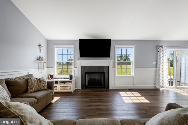 215 Naples Way, Charles Town, WV 25414 - living area with healthy amount of natural light, a fireplace, wainscoting, dark wood finished floors, and vaulted ceiling