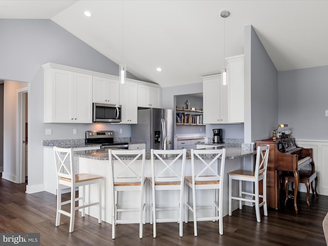 215 Naples Way, Charles Town, WV 25414 - kitchen with stainless steel appliances, a peninsula, white cabinetry, light stone countertops, and hanging light fixtures