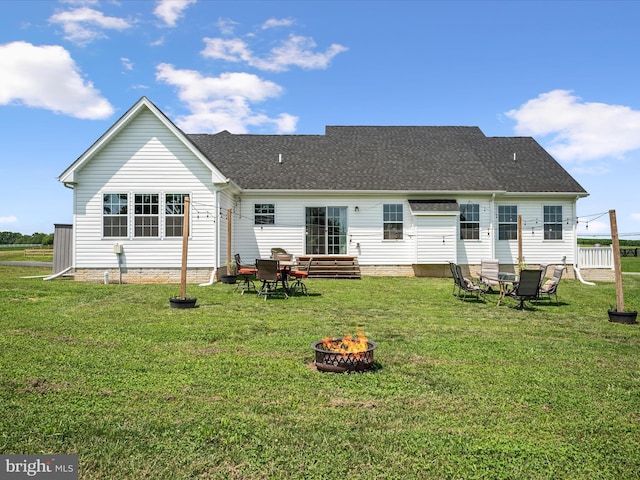 215 Naples Way, Charles Town, WV 25414 - back of house featuring a fire pit, a lawn, and a shingled roof