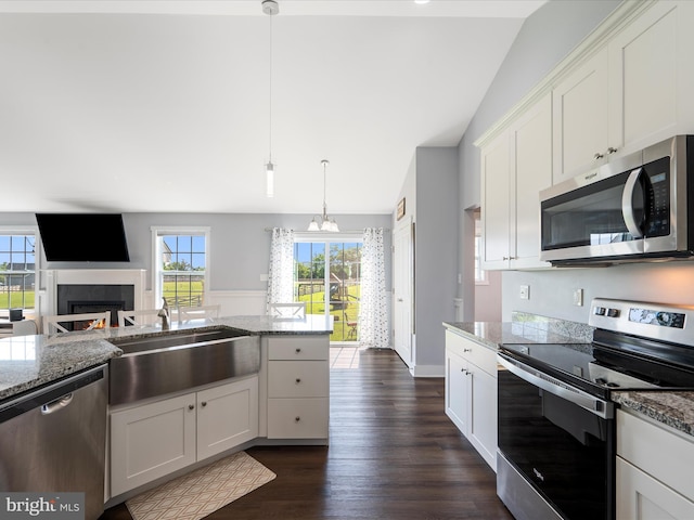 215 Naples Way, Charles Town, WV 25414 - kitchen featuring stainless steel appliances, lofted ceiling, light stone counters, and white cabinets