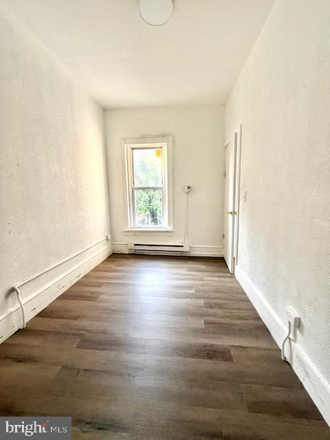 1343 Muhlenberg St, Reading, PA 19602 - unfurnished room with a baseboard heating unit, dark wood-style floors, a textured wall, and baseboards