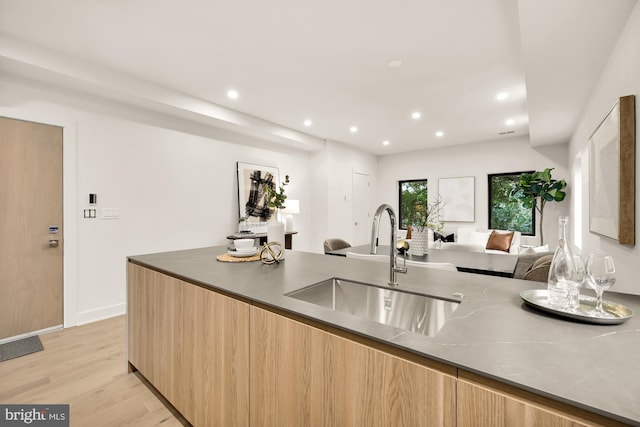 2647 41st St NW Unit 3, Washington, DC 20007 - kitchen featuring modern cabinets, a sink, light wood-style floors, open floor plan, and light brown cabinets