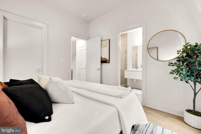 2647 41st St NW Unit 3, Washington, DC 20007 - bedroom with wood finished floors, baseboards, and ensuite bathroom