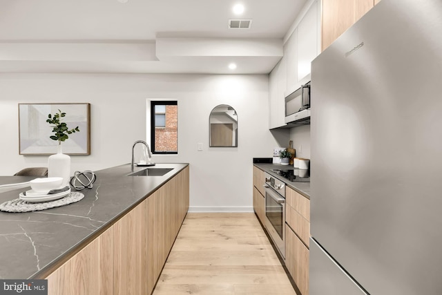 2647 41st St NW Unit 3, Washington, DC 20007 - kitchen featuring stainless steel appliances, a sink, modern cabinets, light wood-type flooring, and recessed lighting