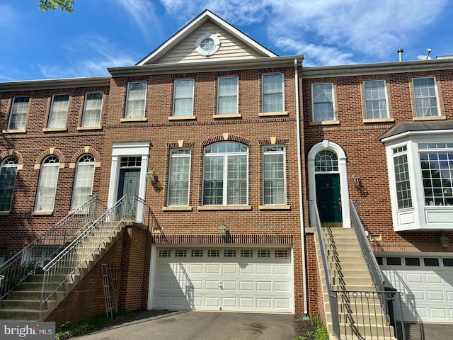 9988 Cyrandall Dr, Oakton, VA 22124 - multi unit property with an attached garage, driveway, and brick siding