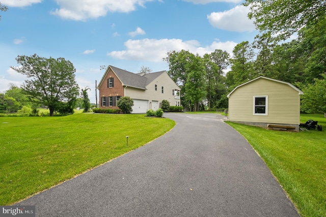 2425 Ellies Way W, Friendship, MD 21794 - view of front facade with an attached garage, a front lawn, driveway, and brick siding