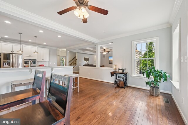 2425 Ellies Way W, Friendship, MD 21794 - dining room with a ceiling fan, ornamental molding, hardwood / wood-style floors, stairway, and baseboards
