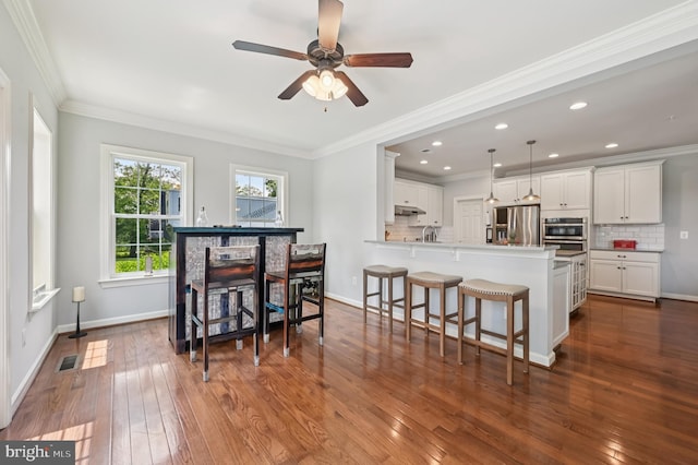 2425 Ellies Way W, Friendship, MD 21794 - dining room featuring dark wood-type flooring, a ceiling fan, baseboards, recessed lighting, and crown molding