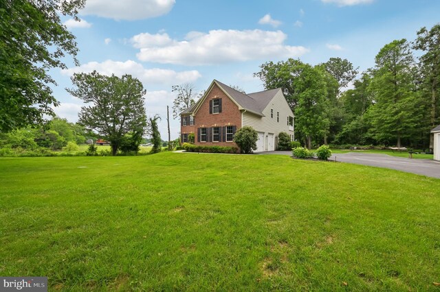 2425 Ellies Way W, Friendship, MD 21794 - view of front of property with brick siding, an attached garage, asphalt driveway, and a front yard