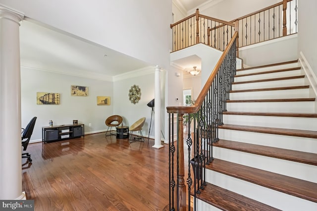 2425 Ellies Way W, Friendship, MD 21794 - stairway with decorative columns, ornamental molding, wood finished floors, baseboards, and a high ceiling