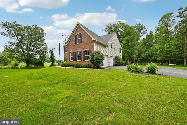 2425 Ellies Way W, Friendship, MD 21794 - view of front facade with brick siding, a garage, asphalt driveway, and a front yard