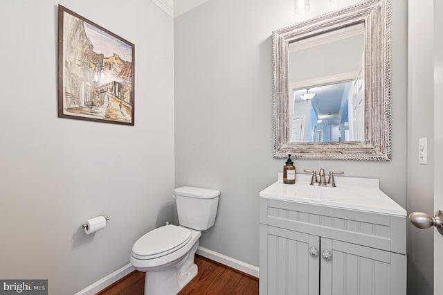 2425 Ellies Way W, Friendship, MD 21794 - bathroom with baseboards, toilet, wood finished floors, vanity, and crown molding