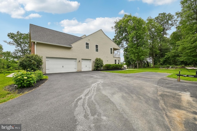 2425 Ellies Way W, Friendship, MD 21794 - view of home's exterior with asphalt driveway, a shingled roof, an attached garage, and a yard