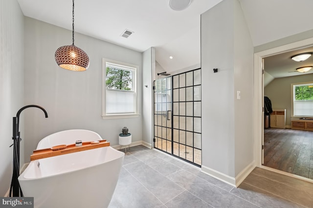 2425 Ellies Way W, Friendship, MD 21794 - full bath featuring tiled shower, vaulted ceiling, a soaking tub, and baseboards