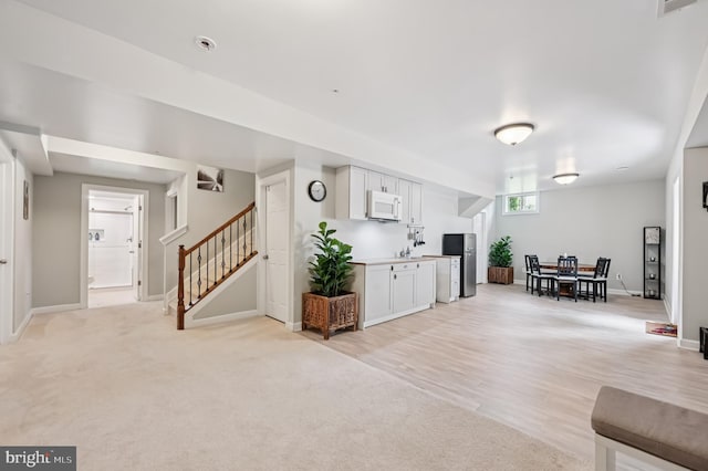 2425 Ellies Way W, Friendship, MD 21794 - living area featuring stairway, baseboards, and light carpet