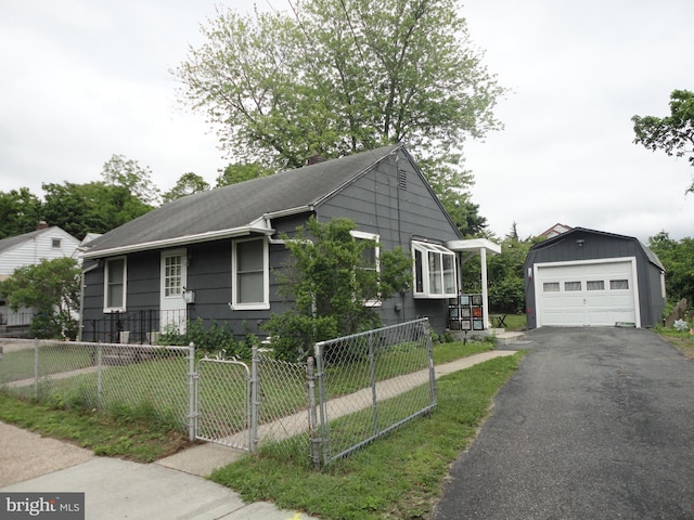 928 Linden, Pleasantville, NJ 08232 - view of front of property featuring an outbuilding, a detached garage, asphalt driveway, a chimney, and roof with shingles