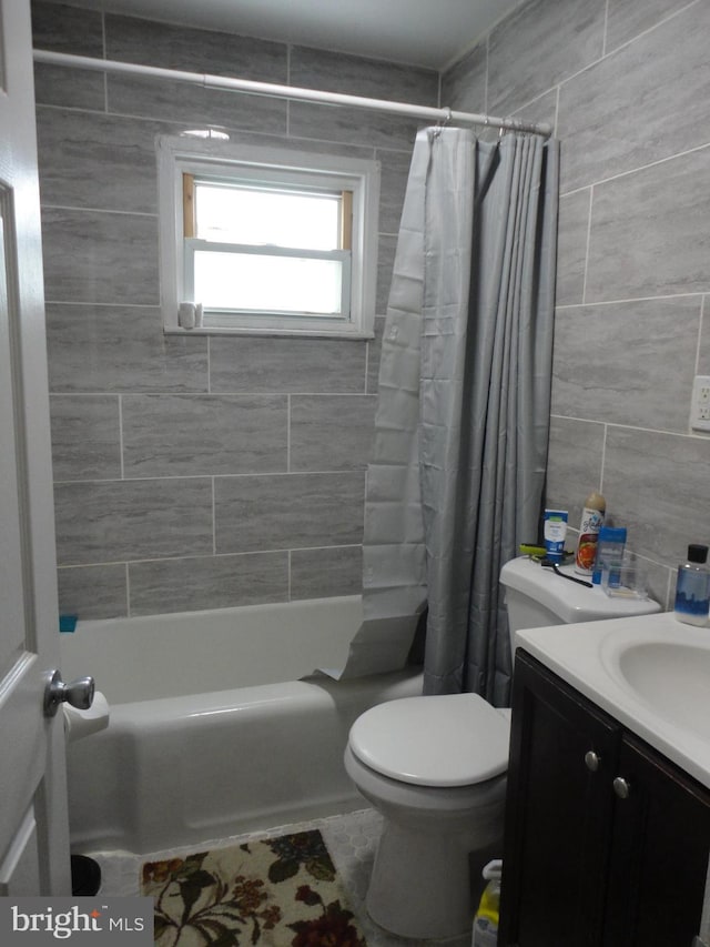 928 Linden, Pleasantville, NJ 08232 - bathroom featuring toilet, vanity, tile walls, and shower / bath combo with shower curtain