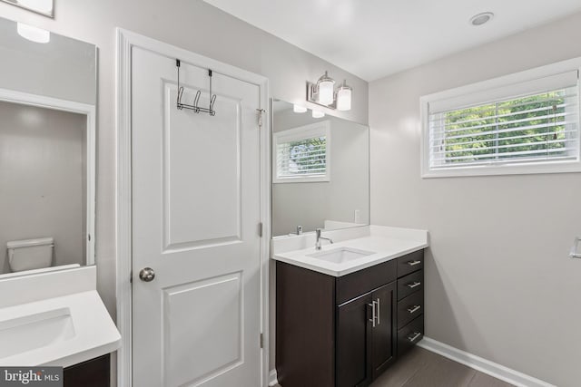 412 Woodcrest Dr SE Unit 412B, Washington, DC 20032 - bathroom featuring vanity, baseboards, toilet, and wood finished floors