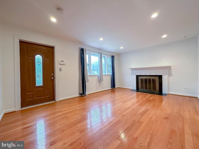8432 Ravenswood Rd, New Carrollton, MD 20784 - unfurnished living room with light wood-style floors, baseboards, a fireplace with flush hearth, and recessed lighting