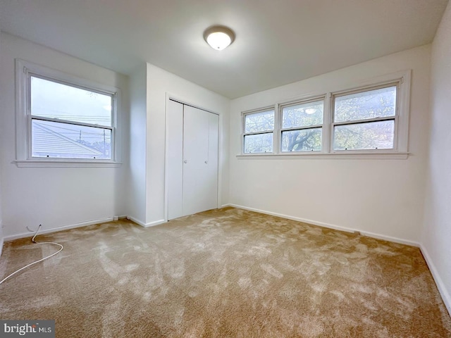 8432 Ravenswood Rd, New Carrollton, MD 20784 - unfurnished bedroom featuring carpet floors, a closet, and baseboards