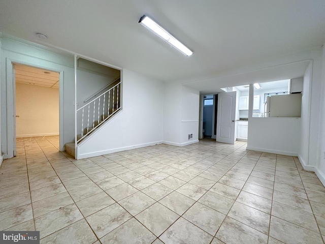 8432 Ravenswood Rd, New Carrollton, MD 20784 - unfurnished room with light tile patterned flooring, stairway, and a smoke detector