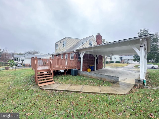 8432 Ravenswood Rd, New Carrollton, MD 20784 - back of property featuring a wooden deck, brick siding, central AC, a yard, and a chimney