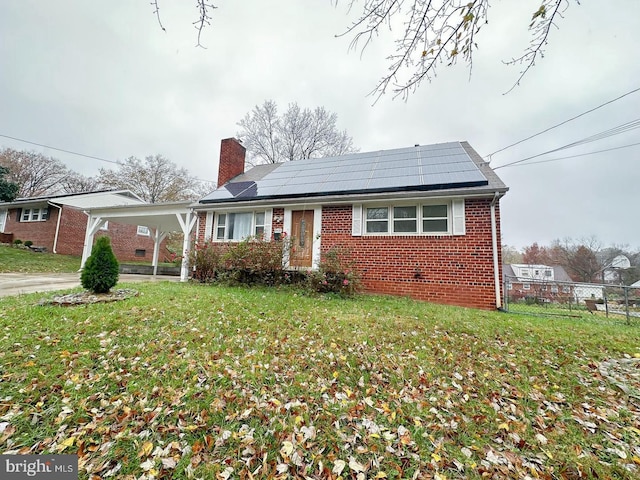 8432 Ravenswood Rd, New Carrollton, MD 20784 - bungalow-style home with brick siding, a chimney, solar panels, an attached carport, and concrete driveway
