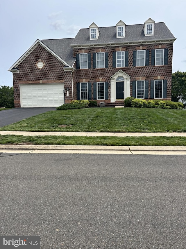6513 Debhill Ln, Gainesville, VA 20155 - colonial home featuring brick siding, a front lawn, an attached garage, and driveway