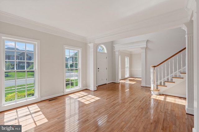 6513 Debhill Ln, Gainesville, VA 20155 - foyer entrance featuring decorative columns, healthy amount of natural light, crown molding, and hardwood / wood-style floors