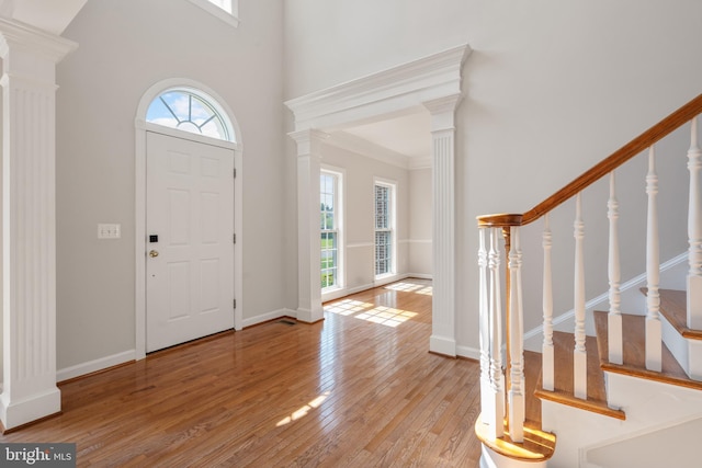 6513 Debhill Ln, Gainesville, VA 20155 - foyer entrance featuring healthy amount of natural light, hardwood / wood-style floors, stairs, a high ceiling, and decorative columns